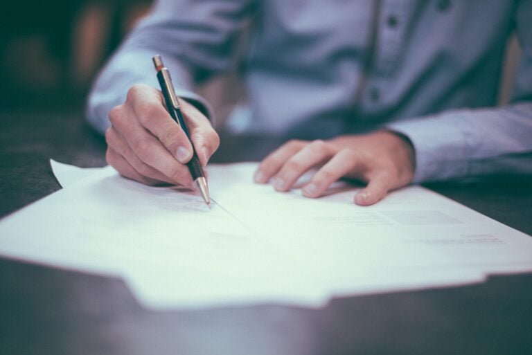 Image of a man filling out paperwork in order to register a foreign business in South Korea.