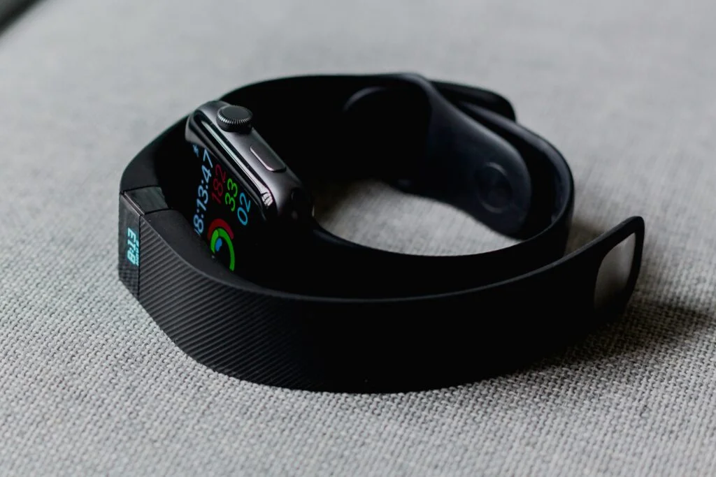 Image showing an Apple Watch and another wearable health tech device showing health tech trends.